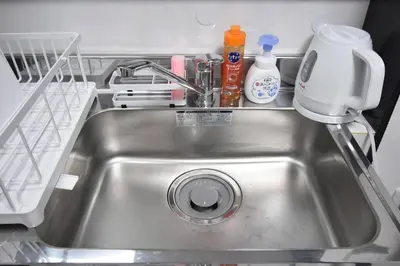 a kitchen sink with a detergent and other kitchen items at \u30a2\u30f3\u30c9\u30b9\u30c6\u30a4\u6587\u82b11\u4e01\u76ee in Tokyo