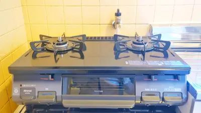 a stove top with two burners on top of it at CowCow Hotel Shinjuku in Tokyo