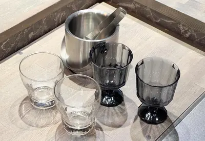 four empty glasses sitting on top of a table at NEXUS HOTEL Gotanda in Tokyo