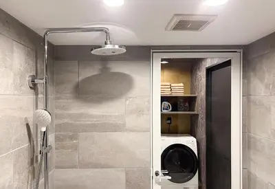 a bathroom with a washing machine in a shower at NEXUS HOTEL Gotanda in Tokyo