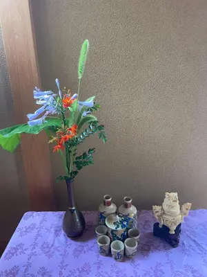 a purple table with a vase with a flower in it at SUZUNONE The only private lodging in Tokyo 2 min walk natural hot springs near BIG super market ASAKUSA AKIHABARA SKYTREE nearby Japanese TATAMI style 70m2 in Tokyo