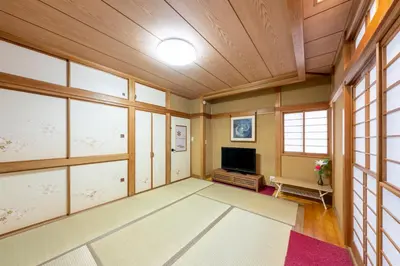 a large living room with wooden ceilings and a flat screen tv at SUZUNONE The only private lodging in Tokyo 2 min walk natural hot springs near BIG super market ASAKUSA AKIHABARA SKYTREE nearby Japanese TATAMI style 70m2 in Tokyo