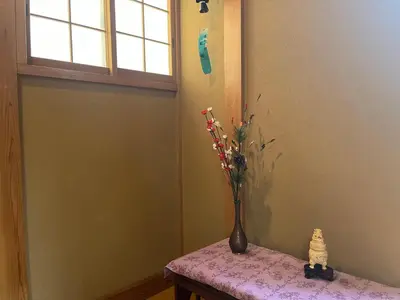 a vase with flowers in it sitting on a table at SUZUNONE The only private lodging in Tokyo 2 min walk natural hot springs near BIG super market ASAKUSA AKIHABARA SKYTREE nearby Japanese TATAMI style 70m2 in Tokyo