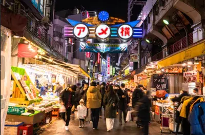 a crowd of people walking through a market at night at SUZUNONE The only private lodging in Tokyo 2 min walk natural hot springs near BIG super market ASAKUSA AKIHABARA SKYTREE nearby Japanese TATAMI style 70m2 in Tokyo