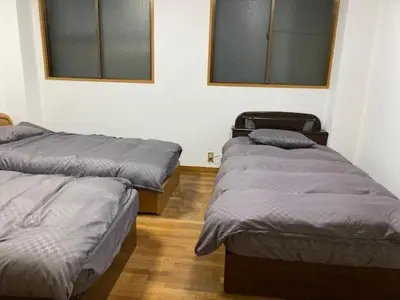 a room with two beds and two windows at Sky Tree INN Ⅱ（晴樹宿Ⅱ） in Tokyo