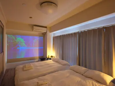 two beds in a room with a large window at Oyama pantheon in Tokyo