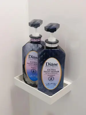two bottles of cleaner sitting on a shelf at Oyama pantheon in Tokyo