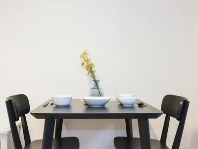 a wooden table with three bowls and a vase on it at Oyama pantheon in Tokyo