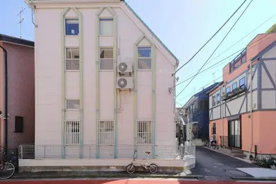 a white building with a bike parked in front of it at Mi-LOFT SHIBUYA in Tokyo