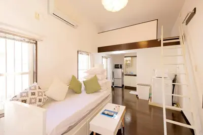a living room with a couch and a loft bed at Mi-LOFT SHIBUYA in Tokyo