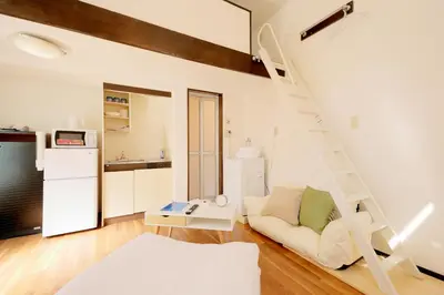 a living room with a ladder and a couch at Mi-LOFT SHIBUYA in Tokyo