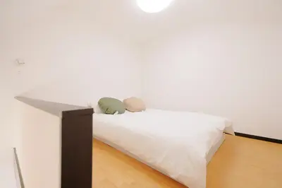 a white bed with two pillows on top of it at Mi-LOFT SHIBUYA in Tokyo