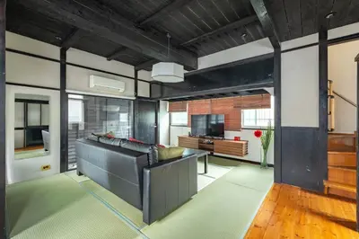 a living room with a couch and a television at SKY GATEスカイツリー徒歩3分の貸切ヴィラ/成田羽田直通/浅草徒歩15分 in Tokyo
