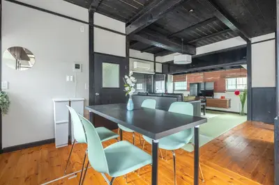 a dining room and living room with a table and chairs at SKY GATEスカイツリー徒歩3分の貸切ヴィラ/成田羽田直通/浅草徒歩15分 in Tokyo