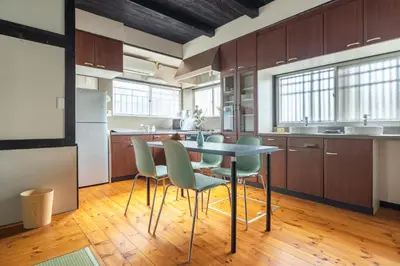 a kitchen with a table and chairs in a room at SKY GATEスカイツリー徒歩3分の貸切ヴィラ/成田羽田直通/浅草徒歩15分 in Tokyo