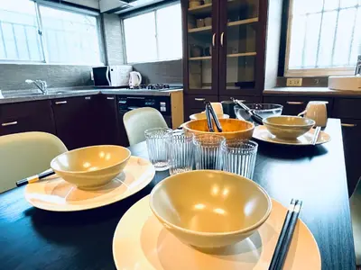a kitchen with bowls and plates on a table at SKY GATEスカイツリー徒歩3分の貸切ヴィラ/成田羽田直通/浅草徒歩15分 in Tokyo
