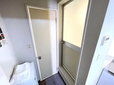 a door in a room with a glass door at Gest Residence EDORIVER Airport Line Self check in in Tokyo