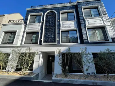 a black and white building with a large window at COMMA HOUSE Shinjuku 2UNITS 2324 in Tokyo