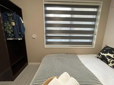 a bedroom with a bed and a window at COMMA HOUSE Shinjuku 2UNITS 2324 in Tokyo