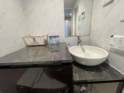 a bathroom with a sink and a counter top at COMMA HOUSE Shinjuku 2UNITS 2324 in Tokyo