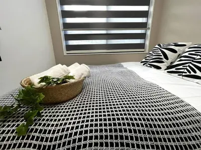 a bedroom with a bed with a plant on it at COMMA HOUSE Shinjuku 2UNITS 2324 in Tokyo