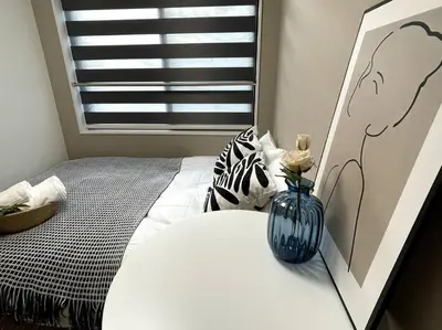 a bedroom with a vase on a bed with a window at COMMA HOUSE Shinjuku 2UNITS 2324 in Tokyo