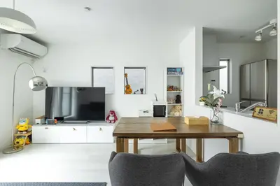 a living room with a table and a tv at HAN Tokyo in Tokyo