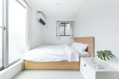 a small bedroom with a bed and a window at HAN Tokyo in Tokyo