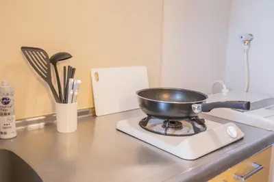 a frying pan on a stove in a kitchen at walk to JR Shibuya sta.-YoE10 in Tokyo