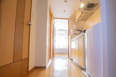a hallway of a kitchen with a refrigerator and a stove at walk to JR Shibuya sta.-EoE3 in Tokyo