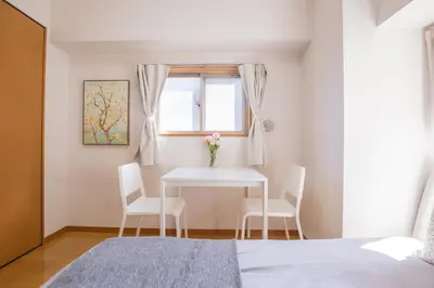 a bedroom with a table and chairs and a window at walk to JR Shibuya sta.-EoE3 in Tokyo