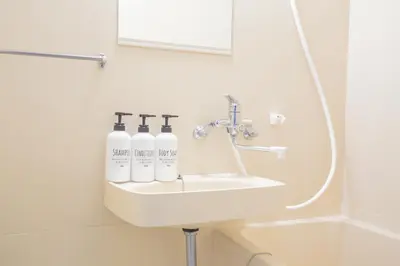 a bathroom sink with three bottles on it at walk to JR Shibuya sta.-EoE3 in Tokyo