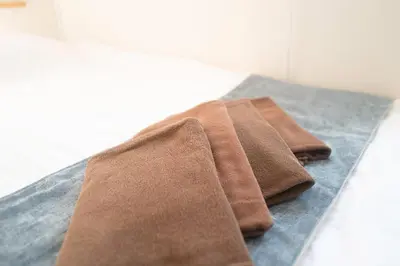 two brown towels sitting on top of a counter at Kaku Studio Apartment Ikebukuro in Tokyo