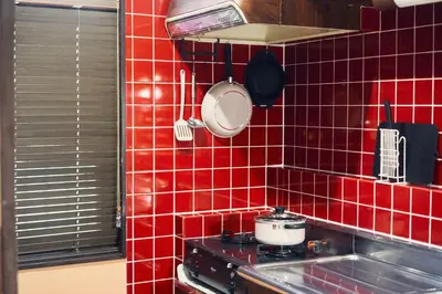 a red tiled kitchen with a stove and a pot at Retro Style Japanese House 10-min walk to Asakusa in Tokyo