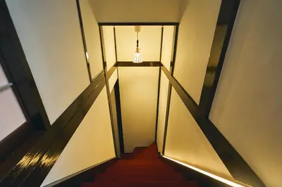 a hallway with a staircase with a light and a stair case at Retro Style Japanese House 10-min walk to Asakusa in Tokyo