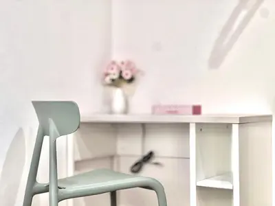 a white desk with a chair and a vase of flowers at ANX Hostel-AD0080 in Tokyo