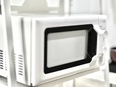 a microwave oven sitting on top of a shelf at ANX Hostel-AD0080 in Tokyo