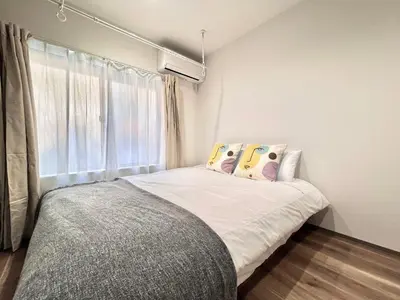 a bedroom with a bed with pillows and a window at ANX Hostel-AD0080 in Tokyo