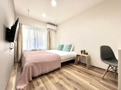 a bedroom with a bed and a window at ANX Hostel-AD0080 in Tokyo