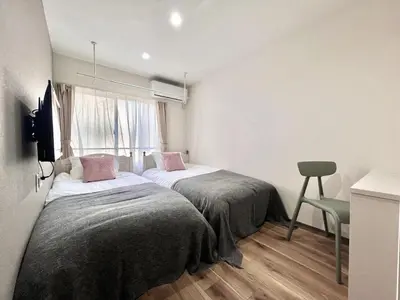 a bedroom with two beds and a window at ANX Hostel-AD0080 in Tokyo