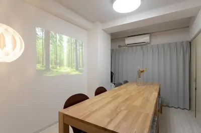 a dining room with a wooden table and chairs at Kamata Smile House - \u84b2\u7530\u3059\u307e\u3044\u308b\u30cf\u30a6\u30b9 in Tokyo