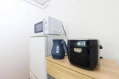 a microwave sitting on top of a counter with a toaster at CoCoHouse Asakusa - SkyTree View, 72\u33a1 in Tokyo