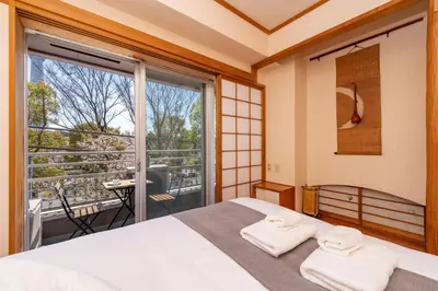 a bedroom with a bed and a large window at CoCoHouse Asakusa - SkyTree View, 72\u33a1 in Tokyo