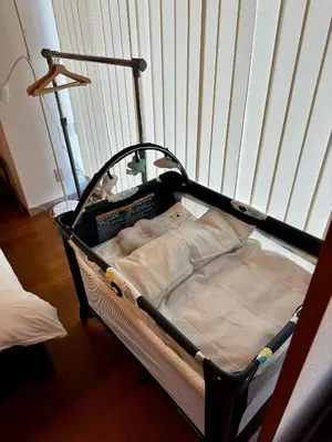 a small bed in a room with a crib at CoCoHouse Asakusa - SkyTree View, 72\u33a1 in Tokyo