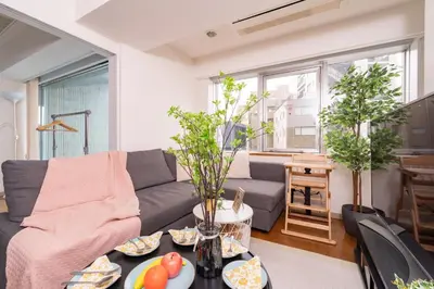 a living room with a couch and a table at CoCoHouse Asakusa - SkyTree View, 72\u33a1 in Tokyo