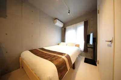 a bedroom with a large bed with a window at [Newly built condominium for rent! ] 5 minutes wal - Vacation STAY 98059v in Tokyo
