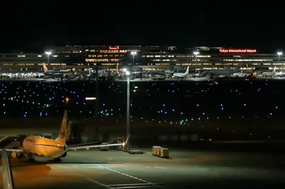 an airplane is parked on the runway at night at [Newly built condominium for rent! ] 5 minutes wal - Vacation STAY 98059v in Tokyo