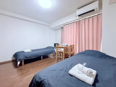 a hotel room with two beds and a desk with a desk at \u30db\u30c6\u30eb\u30b5\u30f3\u30af\u30ea\u30b9\u30bf\u30fc #404 in Tokyo