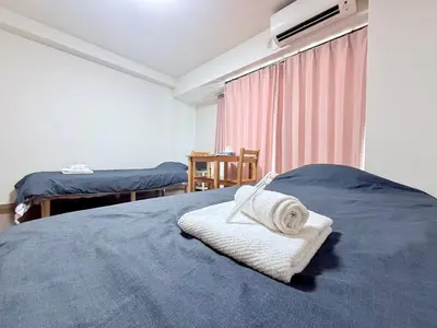 a bedroom with a bed with a towel on it at \u30db\u30c6\u30eb\u30b5\u30f3\u30af\u30ea\u30b9\u30bf\u30fc #404 in Tokyo