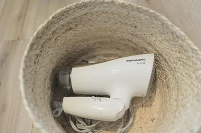 a hair dryer in a basket on a wooden floor at 4min walk to JR Yoyogi Sta 8min to Shinjuku MGW in Tokyo
